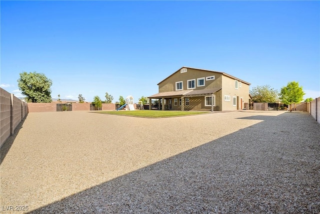 1512 Sagefield Way, Logandale, NV 89021 - back of property with a playground, stucco siding, and a fenced backyard
