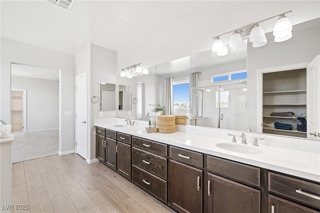1512 Sagefield Way, Logandale, NV 89021 - full bathroom with double vanity, a shower stall, and wood finished floors