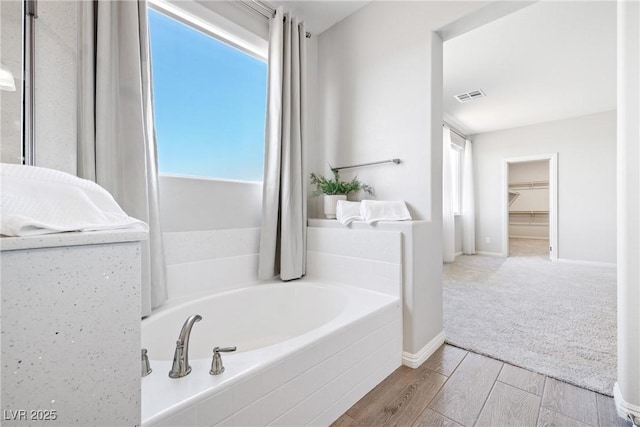 1512 Sagefield Way, Logandale, NV 89021 - full bathroom featuring a garden tub and wood finished floors