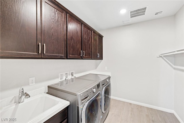 1512 Sagefield Way, Logandale, NV 89021 - laundry area with cabinet space, washing machine and clothes dryer, light wood-style floors, and recessed lighting