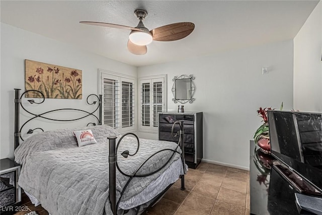 bedroom with ceiling fan and baseboards