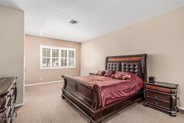 bedroom with baseboards, visible vents, and light colored carpet
