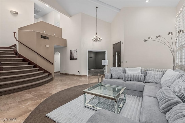 living area featuring an inviting chandelier, visible vents, arched walkways, baseboards, and high vaulted ceiling