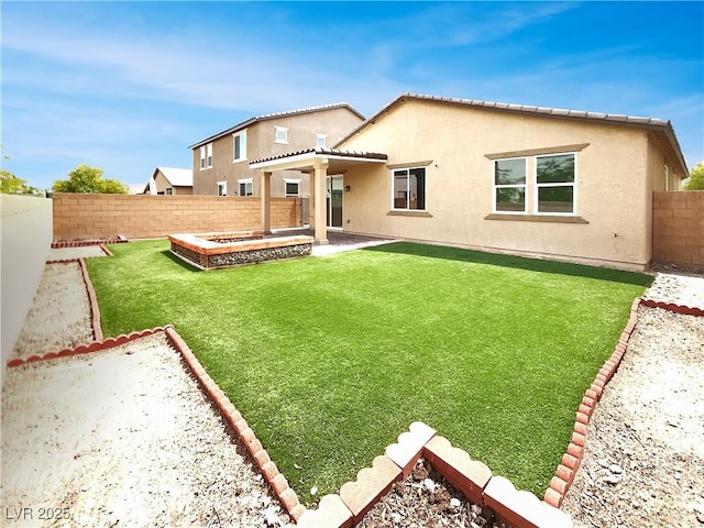 back of property with a patio, a fenced backyard, a yard, and stucco siding