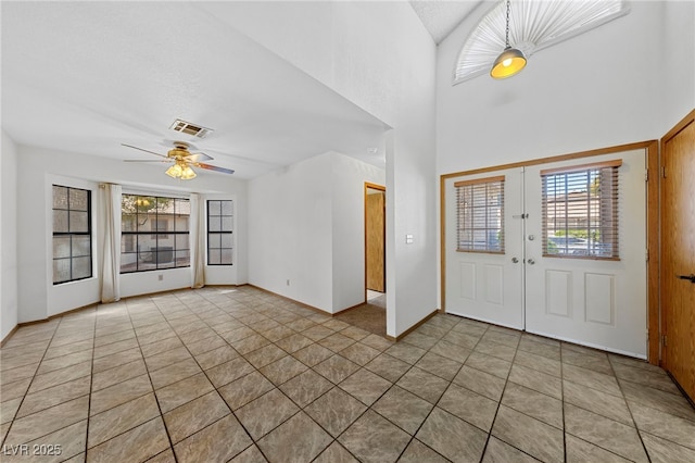 foyer entrance featuring visible vents, light tile patterned floors, french doors, baseboards, and ceiling fan