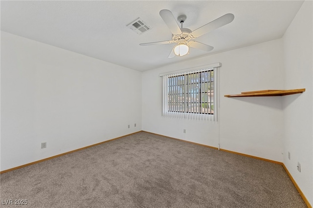 carpeted spare room featuring baseboards, a ceiling fan, and visible vents