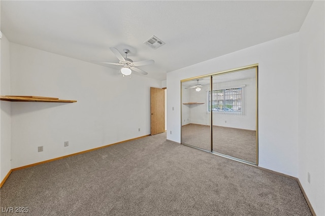 unfurnished bedroom with baseboards, a ceiling fan, visible vents, and carpet floors