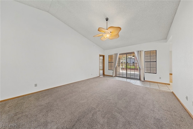 spare room featuring light colored carpet, ceiling fan, vaulted ceiling, and a textured ceiling