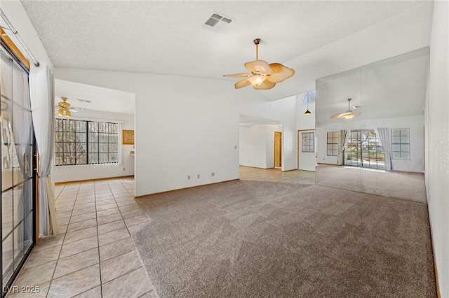 unfurnished living room with visible vents, ceiling fan, and a healthy amount of sunlight