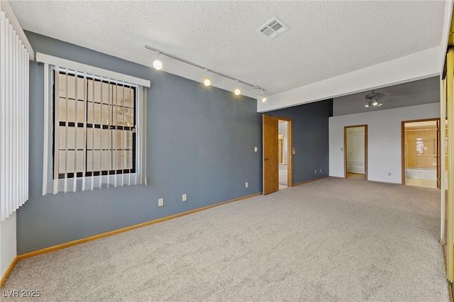 spare room with ceiling fan, baseboards, carpet flooring, and visible vents