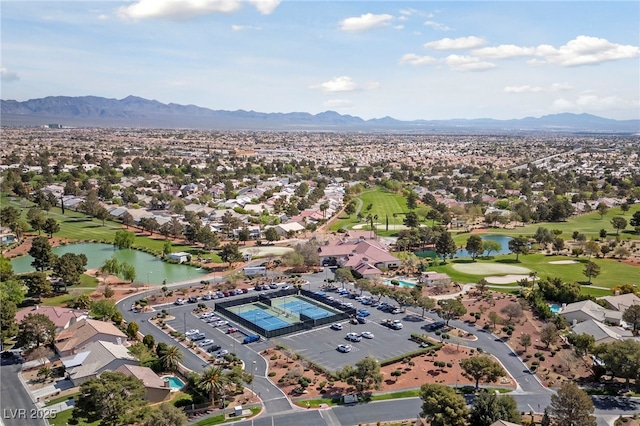 birds eye view of property featuring view of golf course and a water and mountain view