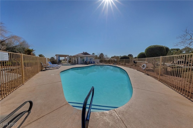 community pool with fence and a patio area