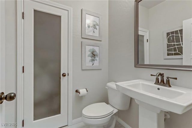 8992 Sparkling River Ct, Las Vegas, NV 89178 - bathroom with baseboards, toilet, and a sink