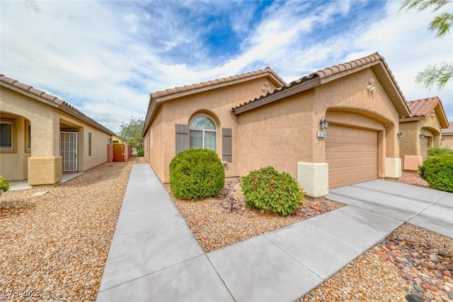 6116 Tokara Ave, Las Vegas, NV 89122 - mediterranean / spanish-style home with stucco siding, an attached garage, concrete driveway, and a tiled roof