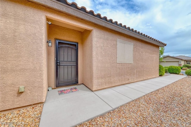 6116 Tokara Ave, Las Vegas, NV 89122 - doorway to property with stucco siding