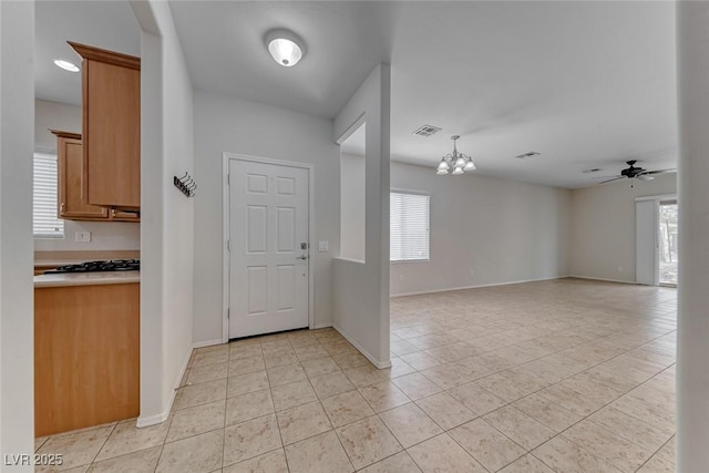 6116 Tokara Ave, Las Vegas, NV 89122 - entryway featuring baseboards, ceiling fan with notable chandelier, visible vents, and light tile patterned floors