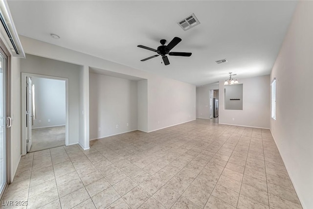 6116 Tokara Ave, Las Vegas, NV 89122 - spare room featuring light tile patterned floors, visible vents, and ceiling fan with notable chandelier