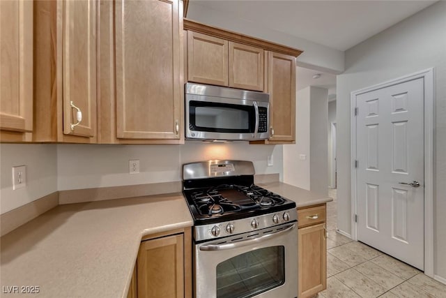 6116 Tokara Ave, Las Vegas, NV 89122 - kitchen featuring appliances with stainless steel finishes, light brown cabinetry, and light countertops
