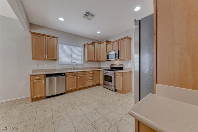 6116 Tokara Ave, Las Vegas, NV 89122 - kitchen with stainless steel appliances, light countertops, visible vents, and a sink