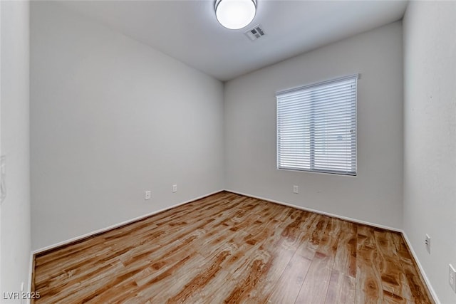 6116 Tokara Ave, Las Vegas, NV 89122 - spare room with baseboards, wood finished floors, and visible vents