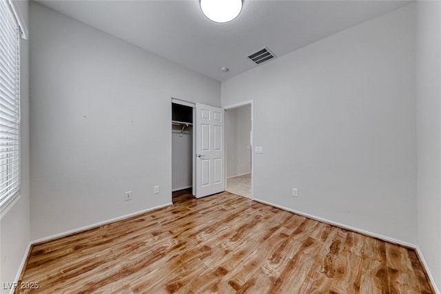 6116 Tokara Ave, Las Vegas, NV 89122 - unfurnished bedroom featuring a closet, wood finished floors, visible vents, and baseboards