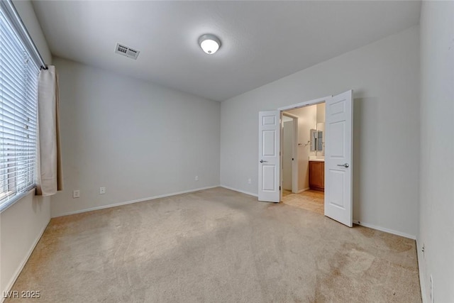 6116 Tokara Ave, Las Vegas, NV 89122 - unfurnished bedroom featuring visible vents, light colored carpet, and multiple windows