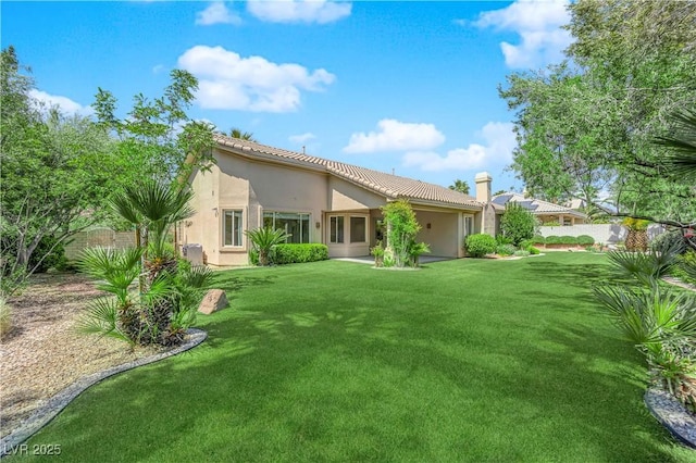 4722 Blue Mesa Way, Las Vegas, NV 89129 - rear view of house with stucco siding, a lawn, and a tile roof