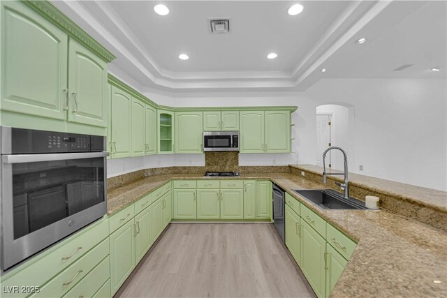 4722 Blue Mesa Way, Las Vegas, NV 89129 - kitchen with a sink, appliances with stainless steel finishes, a tray ceiling, light wood-type flooring, and green cabinetry