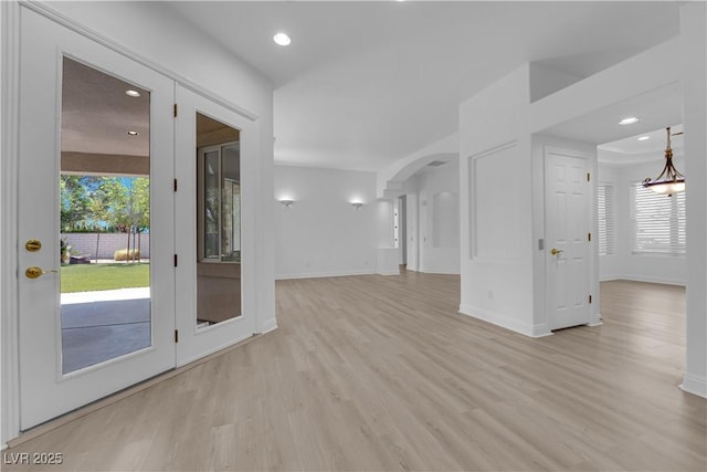 4722 Blue Mesa Way, Las Vegas, NV 89129 - unfurnished living room with light wood-style floors, healthy amount of natural light, arched walkways, baseboards, and recessed lighting