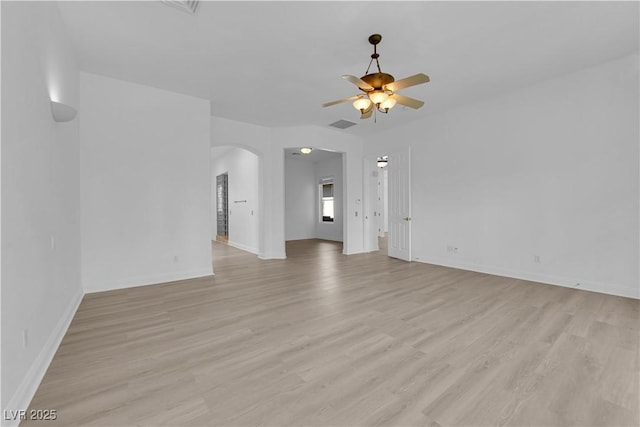 4722 Blue Mesa Way, Las Vegas, NV 89129 - unfurnished living room featuring arched walkways, a ceiling fan, light wood-style flooring, and baseboards