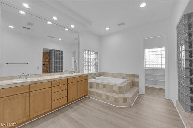 4722 Blue Mesa Way, Las Vegas, NV 89129 - full bath featuring recessed lighting, a bath, wood finished floors, double vanity, and tiled shower