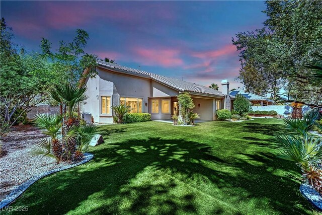 4722 Blue Mesa Way, Las Vegas, NV 89129 - back of property with stucco siding and a lawn