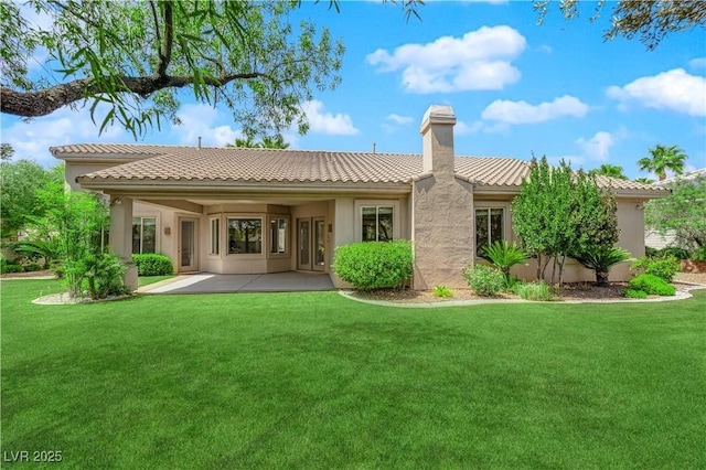 4722 Blue Mesa Way, Las Vegas, NV 89129 - back of house featuring a lawn, stucco siding, a tiled roof, and a patio
