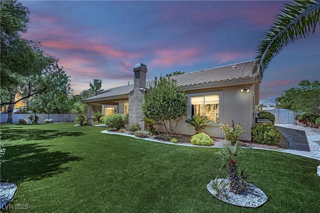 4722 Blue Mesa Way, Las Vegas, NV 89129 - back of property at dusk featuring stucco siding, a tile roof, and a chimney