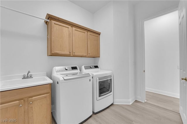 4722 Blue Mesa Way, Las Vegas, NV 89129 - laundry area featuring washer and clothes dryer, light wood-type flooring, cabinet space, and baseboards