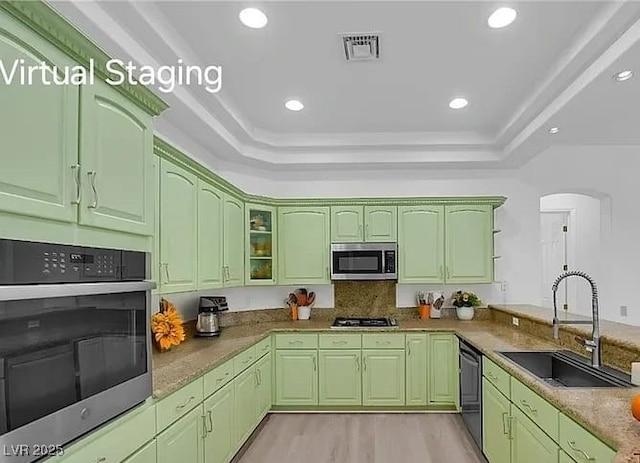 4722 Blue Mesa Way, Las Vegas, NV 89129 - kitchen with a sink, stainless steel appliances, green cabinetry, a tray ceiling, and light wood-style floors