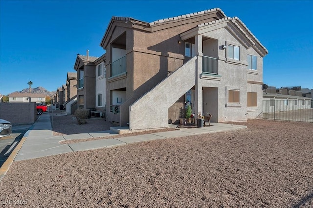 3953 Rebecca Raiter Ave Unit 202, Las Vegas, NV 89110 - exterior space featuring fence, stucco siding, a balcony, and a residential view