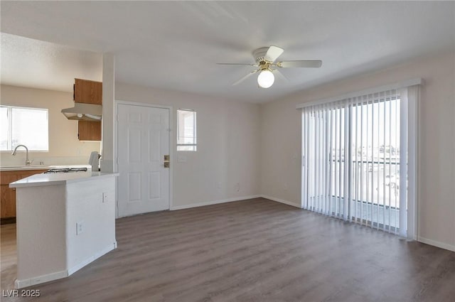 3953 Rebecca Raiter Ave Unit 202, Las Vegas, NV 89110 - kitchen featuring light countertops, a ceiling fan, under cabinet range hood, and wood finished floors