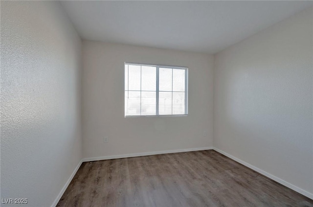3953 Rebecca Raiter Ave Unit 202, Las Vegas, NV 89110 - spare room featuring baseboards and wood finished floors