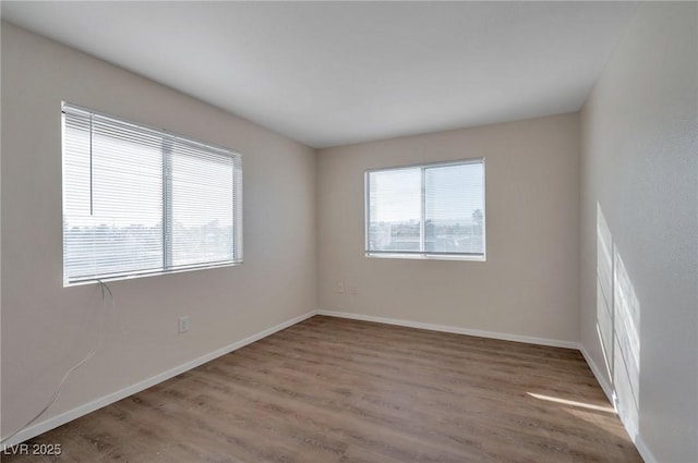 3953 Rebecca Raiter Ave Unit 202, Las Vegas, NV 89110 - spare room featuring baseboards and wood finished floors