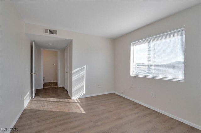 3953 Rebecca Raiter Ave Unit 202, Las Vegas, NV 89110 - unfurnished room with baseboards, visible vents, and wood finished floors