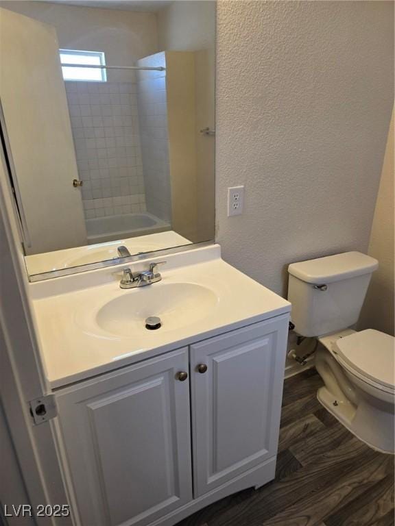 3953 Rebecca Raiter Ave Unit 202, Las Vegas, NV 89110 - bathroom with vanity, a textured wall, toilet, and wood finished floors