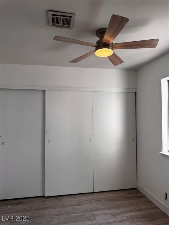 3275 Arville St Unit C, Las Vegas, NV 89102 - unfurnished bedroom featuring a closet, a ceiling fan, and wood finished floors