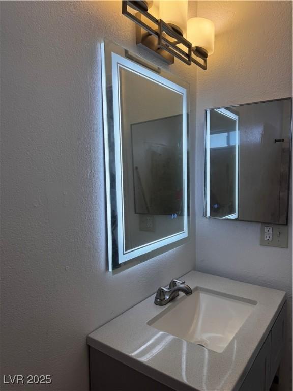 3275 Arville St Unit C, Las Vegas, NV 89102 - bathroom with a textured wall and vanity