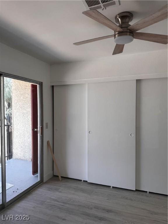 3275 Arville St Unit C, Las Vegas, NV 89102 - unfurnished bedroom with access to outside, wood finished floors, and ceiling fan