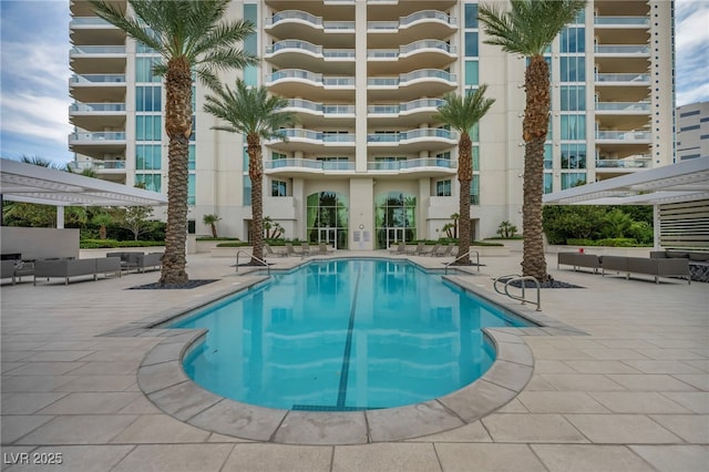 pool featuring an outdoor living space, a pergola, and a patio