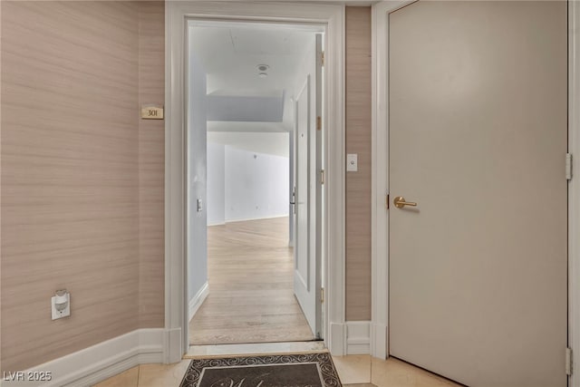 hallway featuring baseboards
