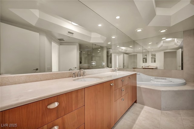 bathroom featuring a sink, a shower stall, double vanity, and visible vents