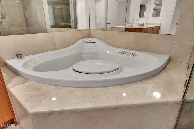 bathroom featuring vanity and a garden tub