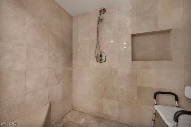 bathroom with a tile shower
